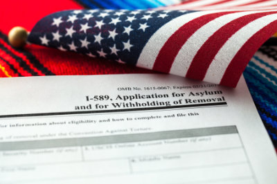 Application for asylum to USA concept with application form and USA flag on mexican serape